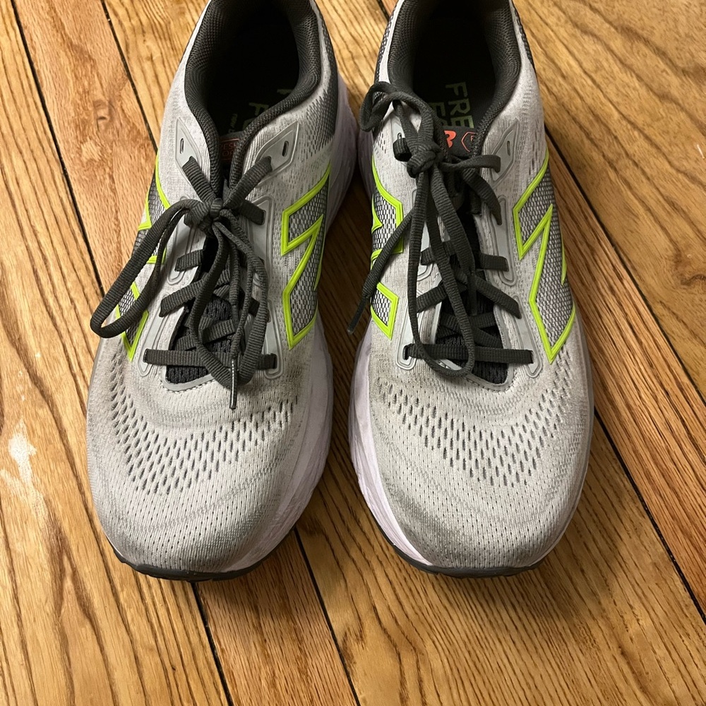 Women’s (10.5) and men’s (9) unisex New Balance Gray and Neon Green shoes.